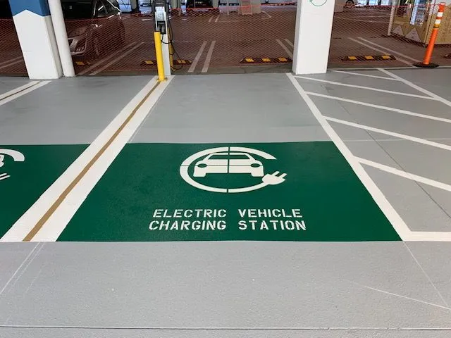 A parking spot with a newly painted marking showing it's for electric vehicles