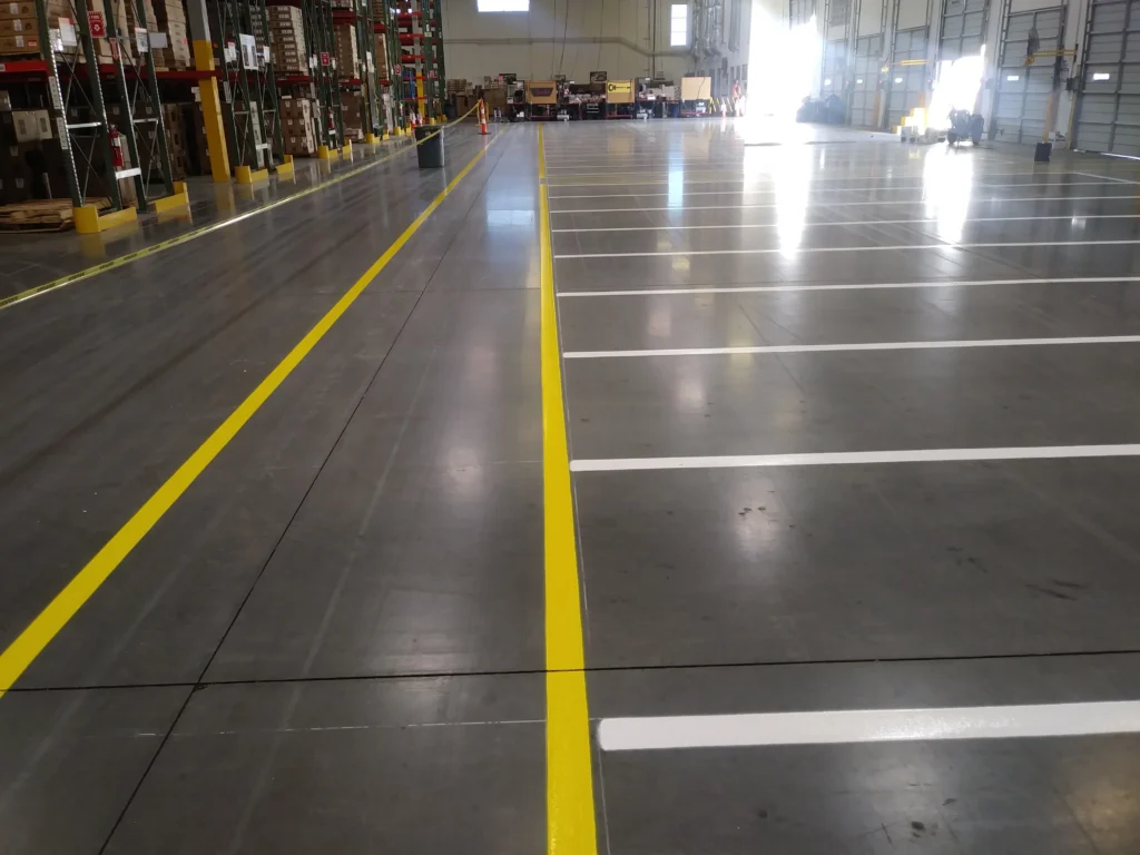 The inside of a warehouse with newly marked yellow and white stripes
